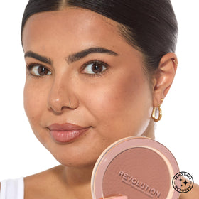 Revolution bronzer on vanity with brushes showing ready-to-use everyday benefit
