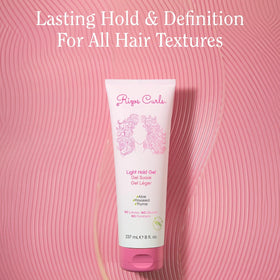 Rizos Curls 2.5 oz travel gel in hand showing compact size for travel