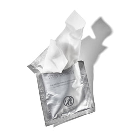RMS Beauty wipe in hand for size comparison and easy portability benefit