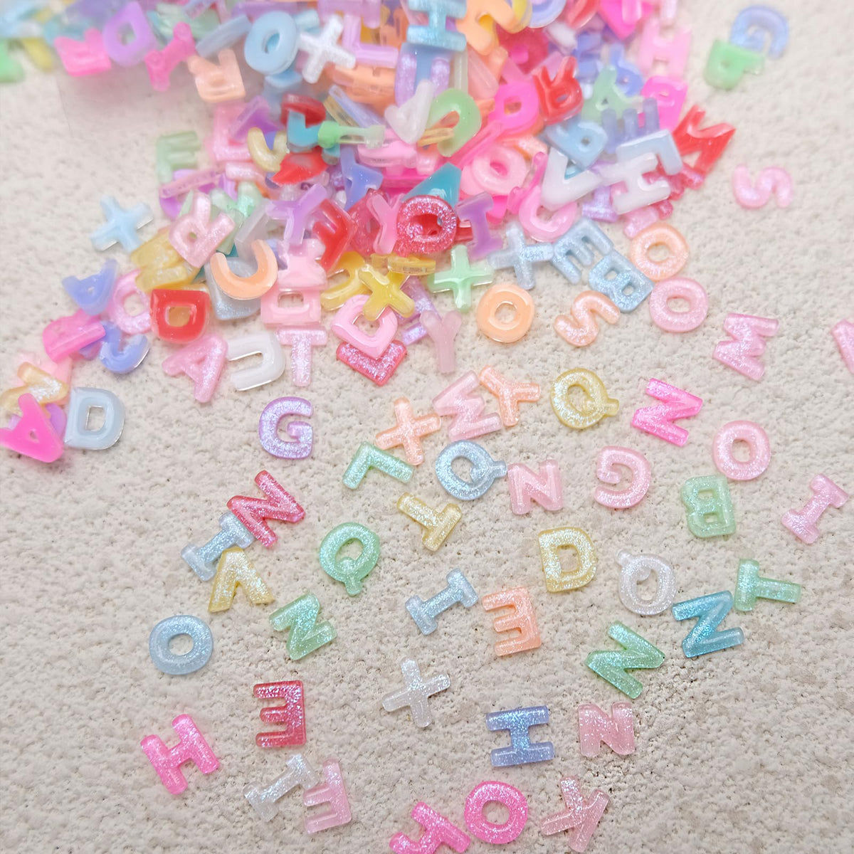 ROFIBUT letter gems applied on a manicure demonstrating playful style