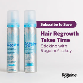Rogaine canister in hand showing compact travel-friendly size
