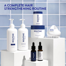 Routine Wellness natural ingredients flatlay emphasizing biotin and plant extracts