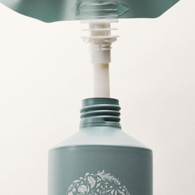 RŌZ pouch beside bottle showing scale and two-refill capacity benefit