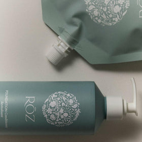 RŌZ pouch pouring conditioner into aluminum bottle for easy refills