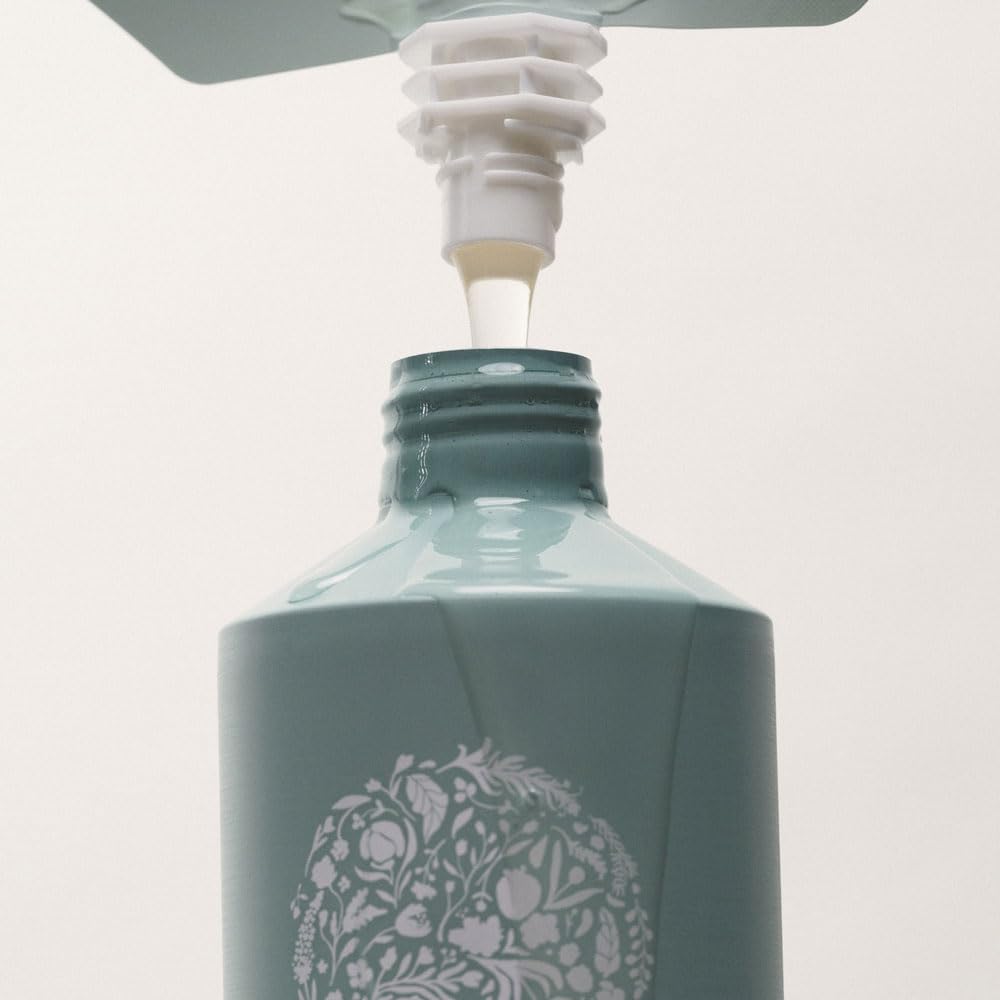 RŌZ pouch being poured into aluminum bottle, refill system reduces plastic waste benefit
