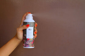 R+Co Centerpiece bottle in hand for size comparison, communicates travel-friendly convenience