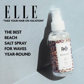 R+Co Rockaway bottle beside hand showing travel-friendly size