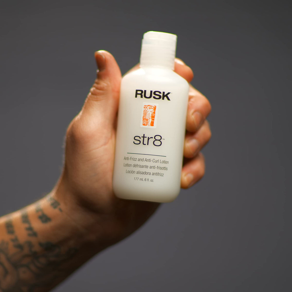 RUSK product in use during blow-dry, helps reduce frizz and temporarily relax curl