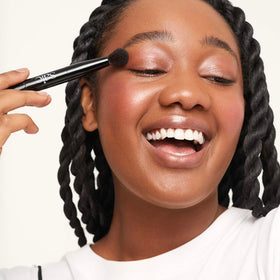 Saie double brush in use applying cream contour and highlight for precision