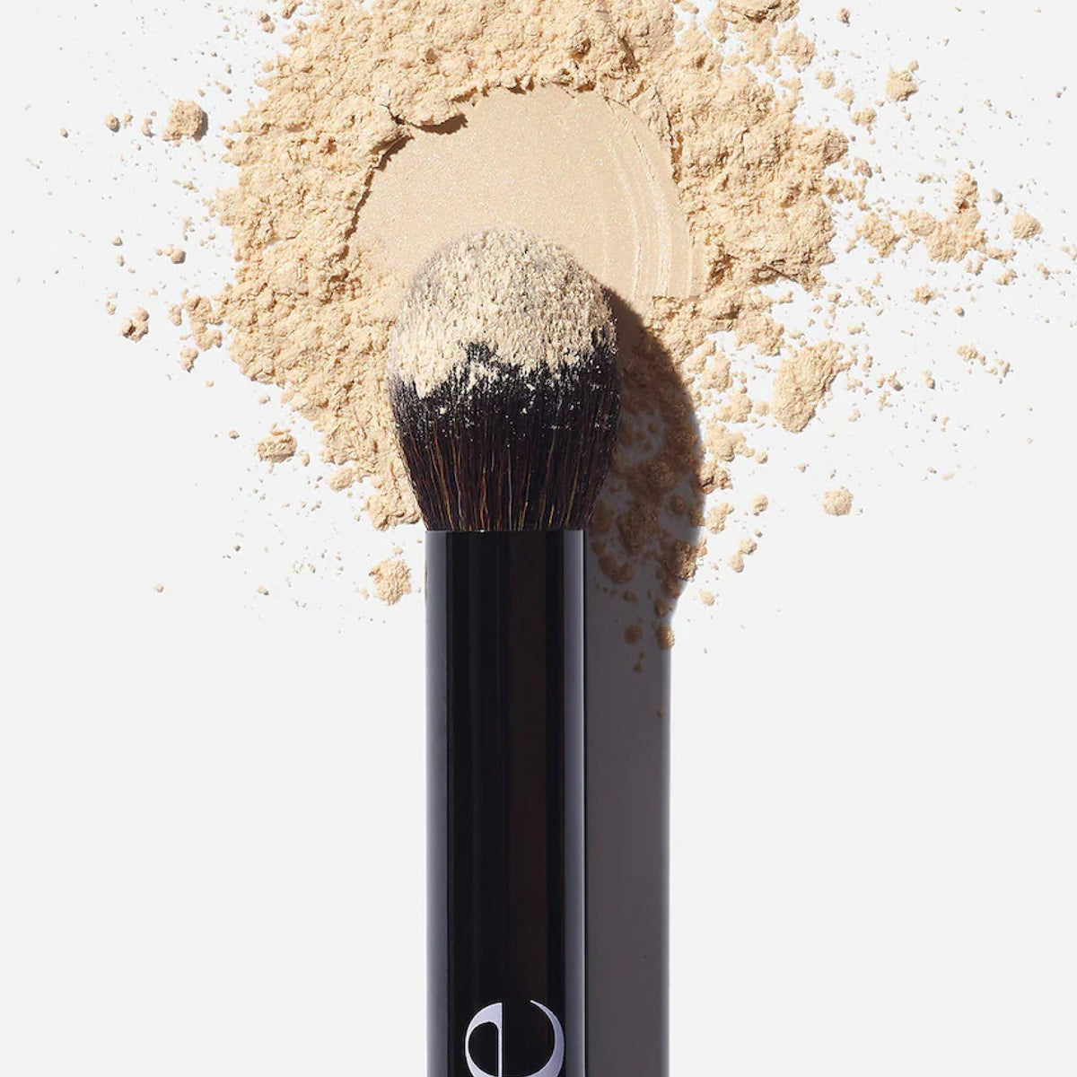 Saie Fluffy Brush held in hand to show palm-sized scale and control