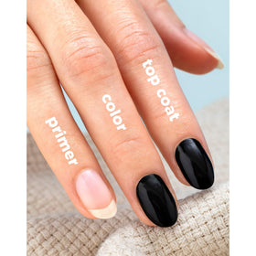 Sally Hansen swatch on nail tip displaying semi-opaque white coverage and modern look