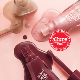 Bottle in hand for Sally Hansen illustrating size and easy at-home manicure convenience