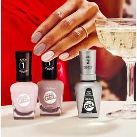 Sally Hansen bottle held in hand showing size and easy-at-home salon convenience