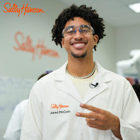 Sally Hansen Rookie Red worn by athlete in active setting showcasing chip-resistant wear benefit