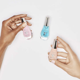 Sally Hansen on a vanity with accessories showing polished, healthier-looking nails