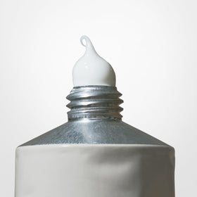 Salt & Stone bottle next to common items for 3.4 fl oz scale