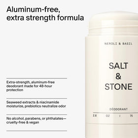 Salt & Stone next to a hand for scale showing compact travel-friendly size