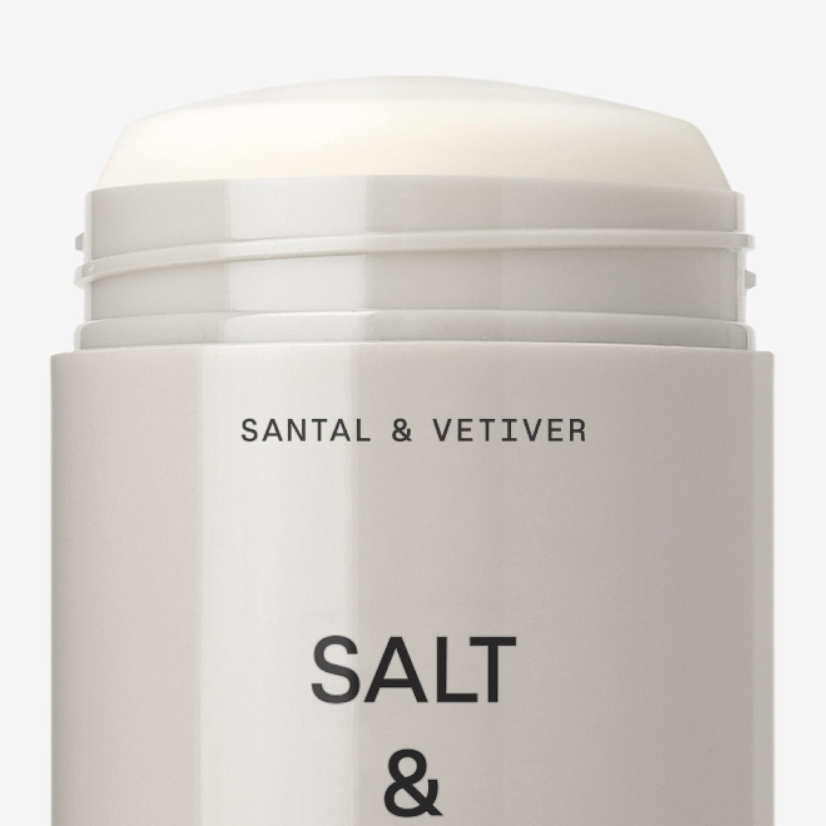 Salt & Stone deodorant next to travel pouch demonstrating compact travel-friendly design