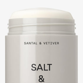 Salt & Stone deodorant next to travel pouch demonstrating compact travel-friendly design