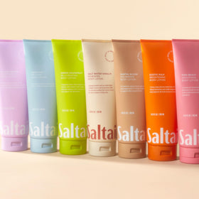 Saltair tubes on bathroom shelf in a styled setting suggesting daily self-care ritual
