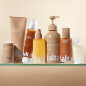 Saltair tubes beside a hand to show 10oz size for travel and home convenience