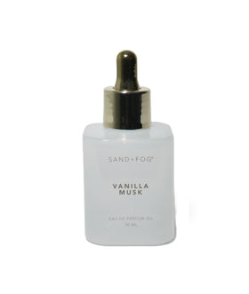 Sand + Fog dropper dispensing oil on wrist, precise application for long-lasting fragrance benefit