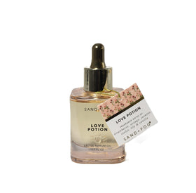 Sand + Fog dropper close-up dispensing oil onto wrist for precise application benefit