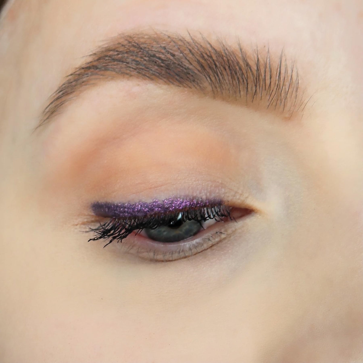 Sandstone Scandinavia eye look created with the pencil showing defined metallic purple eyeliner