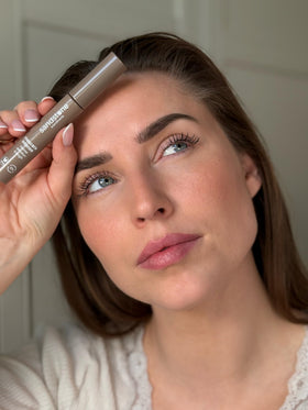 Sandstone Scandinavia mascara in hand scale demonstrating travel-friendly size and easy handling