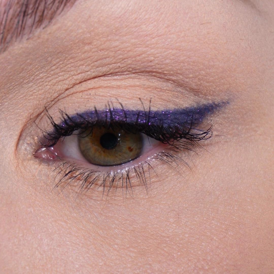 Sandstone Scandinavia swiped stroke on skin showing rich purple metallic payoff and blendability