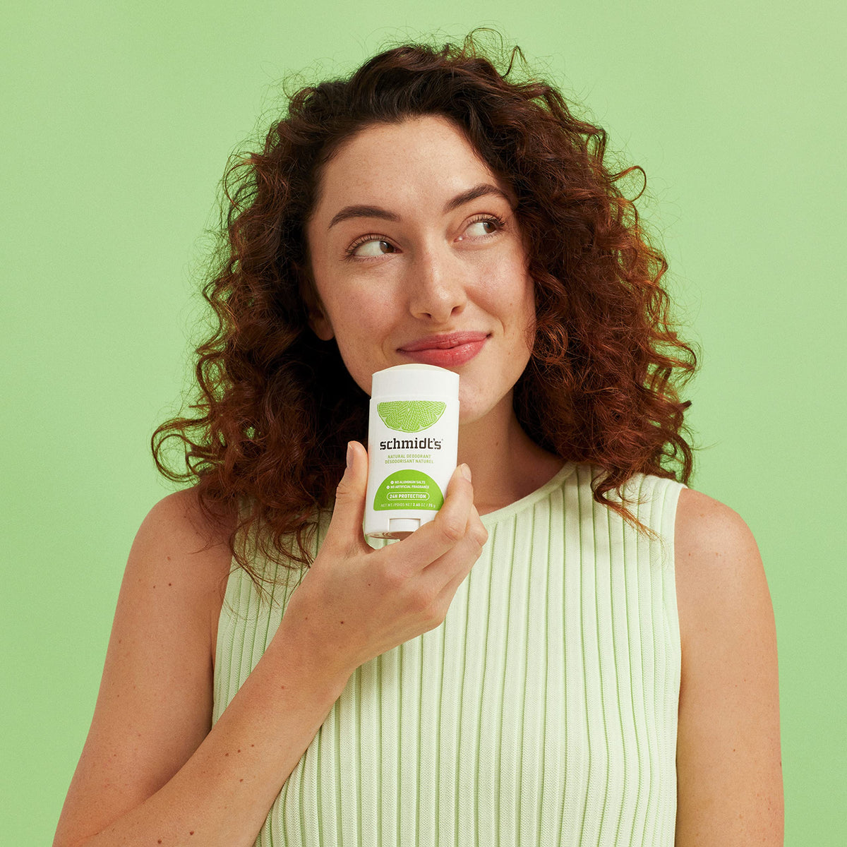 Schmidt's deodorant in hand being applied to underarm illustrating quick 1–2 swipe application benefit