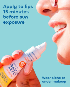 Seaweed Bath Co. woman applying lip shine outdoors for sun protection