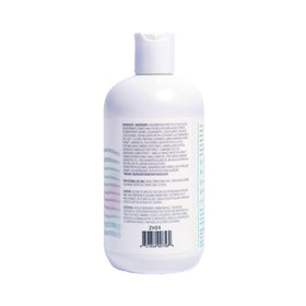 Bottle on bathroom shelf with towels, suggests everyday relaxation ritual