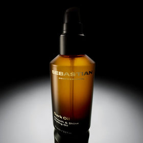 Model styling hair with Sebastian Dark Oil in salon, Sebastian adds body and fragrance