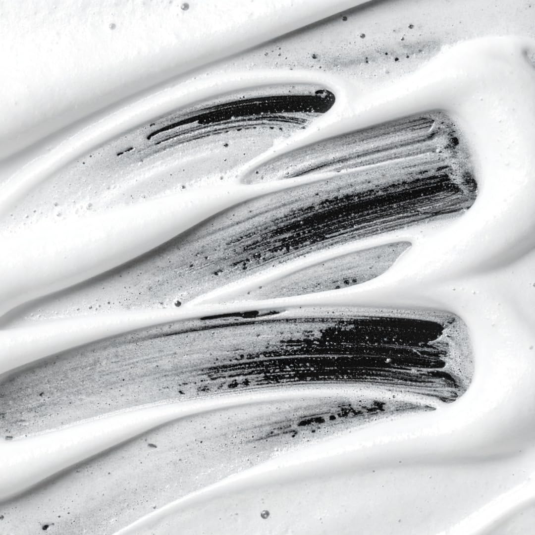 Scrunching dry hair with Sebastian Volupt Thickefy to create textured, fuller-looking hair