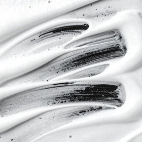 Scrunching dry hair with Sebastian Volupt Thickefy to create textured, fuller-looking hair
