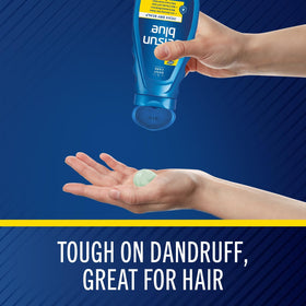 Hand holding Selsun Blue 11 oz bottle to show size and ease of use for at-home care