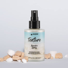 SexyHair bottle held in hand showing 4.2 oz scale for portability