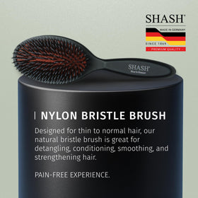 SHASH brush held in hand demonstrating size and scale for everyday use