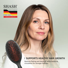 SHASH brush being used on damp hair to detangle gently and minimize breakage