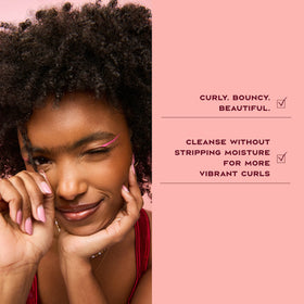 Shea Moisture shampoo applied to wet curls demonstrating defined results