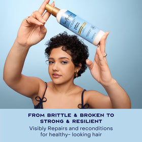 Shea Moisture being applied to damp hair to detangle and smooth