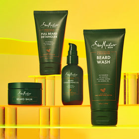 Shea Moisture lifestyle shot of man grooming beard in bathroom for daily routine