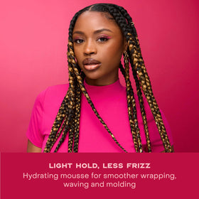 Shea Moisture bottle next to hand showing 7.5 oz size and portability