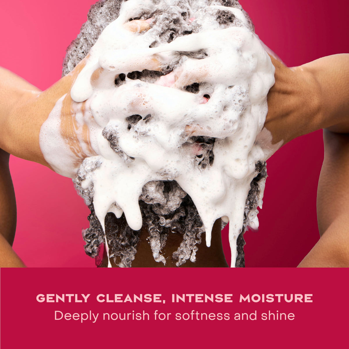 Hand holding Shea Moisture shampoo in shower showing easy application benefit