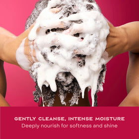 Hand holding Shea Moisture shampoo in shower showing easy application benefit