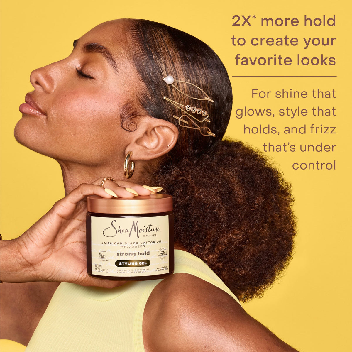 SheaMoisture being smoothed onto a hair strand to control frizz and add shine
