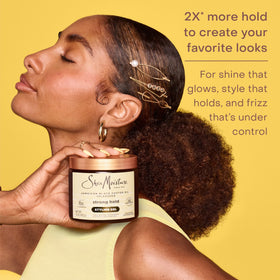 SheaMoisture being smoothed onto a hair strand to control frizz and add shine