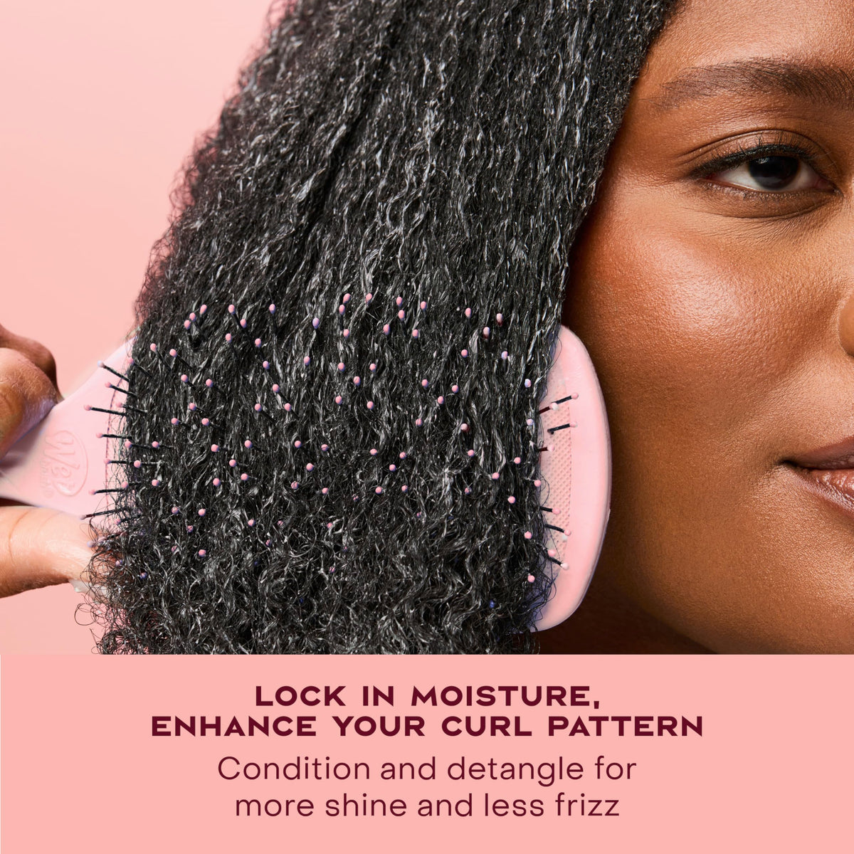 SheaMoisture being applied to damp curls to show detangling and instant definition