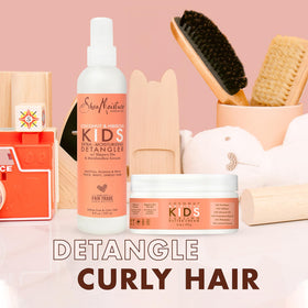 SheaMoisture detangler spray bottle focused on mist delivery for gentle slip